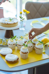 Pastry chef decorates lemon muffins for breakfast