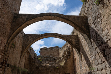 Fototapeta na wymiar ruins and remains of stone arches in the courtyard of a medieval castle