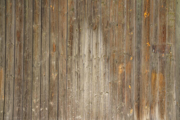 Fragment of a wooden fence. The boards fit tightly to each other.