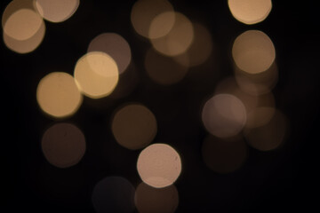 abstract blurred tungsten light bokeh light in the dark night as festive background