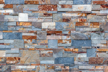 A wall made up of medium to large colored stones