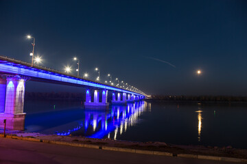 Automobile bridge over the Ob river in Barnaul in autumn at night. Altai Krai, Russia