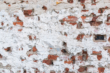 Old chipped white brick wall texture background, whitewashed