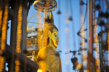 The Face of Buddha Statue standing name as luang phor toh at Wat Intharamwihan temple in Bangkok Thailand