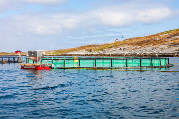 Fish cages in the sea at the coast in Norway