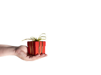 Red simple box, gift, surprise in hand isolated on a white background. Horizontal photo. In the concept of surprise for Valentine's Day, Women's Day, Birthday. A simple gift