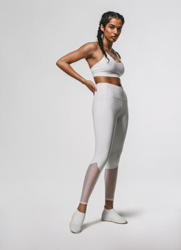 Portrait Of Fitness Woman Standing Against White Background