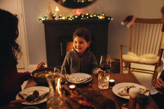 Boy having Christmas dinner with family