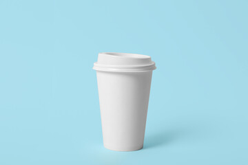 Takeaway paper coffee cup on light blue background