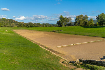Ruins of the Olympic Stadium in the archeological site of Olympia, Greece, a major Panhellenic...