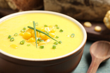 Delicious creamy corn soup on table, closeup