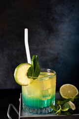 cocktail with orange juice and blue curacao liqueur in a glass