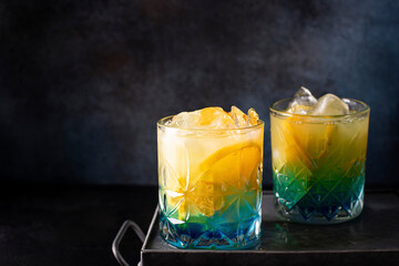 blue curacao cocktail with orange juice and orange slices