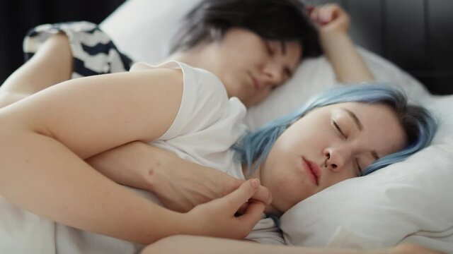 Zoom out video of lesbian couple sleeping together in bed.  Shot with RED helium camera in 8K
