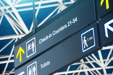 Directions on the sign at the airport - Check in Counters and Toilets.