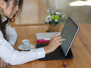 Female office worker working with digital tablet