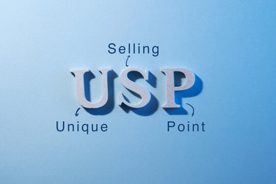 close up of aphabet usp on blue background  -word unique selling point