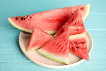 Yummy cut watermelon on light blue wooden table, closeup