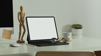 Home office desk with digital tablet, computer, glasses and decorations, clipping path