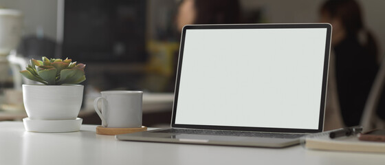 Workspace with laptop, supplies, plant pot and coffee mug in office room, clipping path