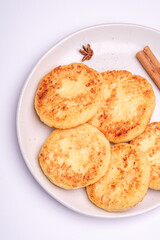Cottage cheese fritters. Christmas breakfast mood with anise and cinnamon on white background, top view