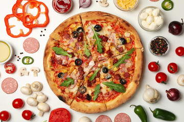 Pizza and ingredients on white background, top view