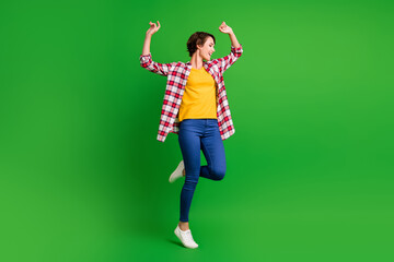 Fototapeta na wymiar Full size profile photo of adorable funky lady dancing wear jeans shirt sneakers isolated on green background