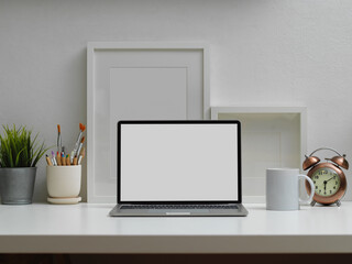 Home office interior design with laptop, paint brushes and decorations, clipping path