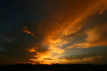 Fototapeta na wymiar Twilight with orange clouds and blue sky