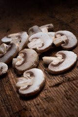 slices of champignon mushrooms over a wooden background. sliced mushrooms. mushrooms close up