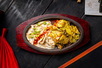 Roasted potatoes with stewed chicken in pan