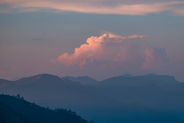 Fototapeta na wymiar Beautiful sunrise over the mountain range and sea clouds