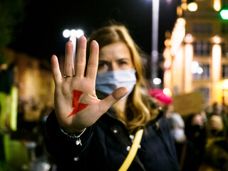 Polish Woman has drawn a sign red lightning on her hand. Women Protest against tightening of the abortion law in Poland.