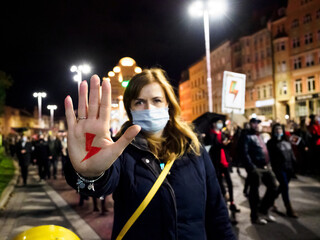 Polish Woman has drawn a sign red lightning on her hand. Women Protest against tightening of the...