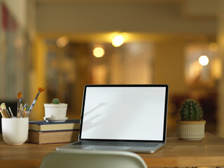 Workspace with laptop, books, stationery and decorations, clipping path