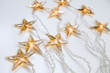 Star shaped Christmas lights against white background with copy space