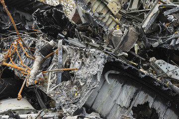 Plane wreckage, parts of the fuselage of a burned and broken aircraft at a non-ferrous scrap dump for recycling.