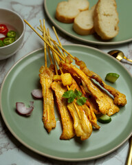 Grilled pork satay (Moo Satay) served with peanut sauce  and side dish, Asian street food