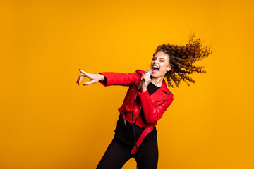 Portrait of nice attractive glad cheerful wavy-haired girl solo vocalist star singing hit stage...