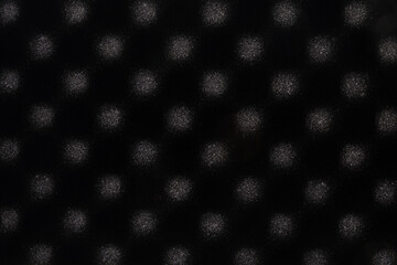 Black sponge abstract background with round soft light patterns