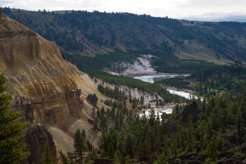 The Grand Canyon of Yellowstone, in Yellowstone National Park, Wyoming. The reason for the colours of the rhyolite rocks is that they are oxidising, or rusting due to their iron content.