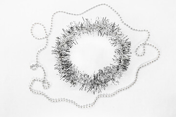 New year decorations for text. Silver beads, chain of balls, empty blank circle tinsel. on a white background. Christmas concept.