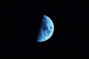 Half moon on black background. Close up Image. Bright lunar sa