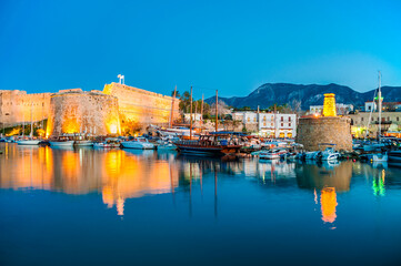 Fototapeta premium Blue hour view in Kyrenia harbour on . Kyrenia harbor is a famous tourist resort.
