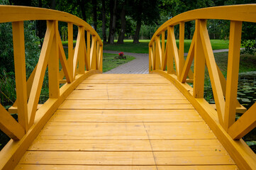 Empty arched wooden pedestrian bridge