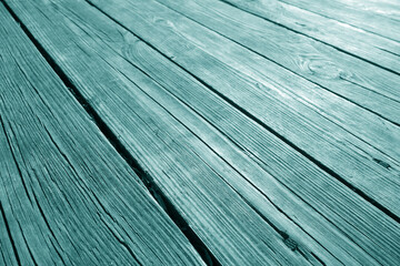 Old wooden terrace floor close-up with blur effect in cyan color