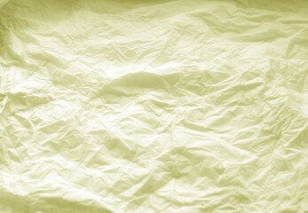 Crumpled paper background in yellow tone.