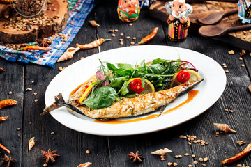 Fried fish stuffed with fresh greens and lemons
