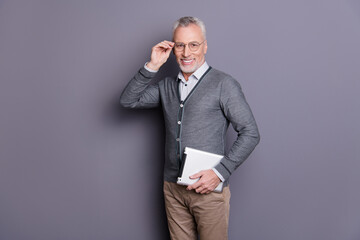 Portrait of his he nice attractive cheerful cheery content business shark wearing casual formal-wear carrying e-book e-commerce isolated over gray pastel background