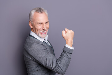 Profile side view portrait of his he nice attractive well-groomed positive cheerful cheery business shark wearing casual formal-wear rejoice good news isolated over gray pastel background